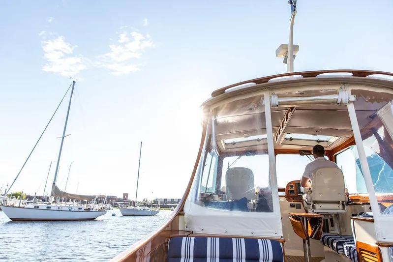 Gracious Yacht Photos Pics 2011 Hinckley Picnic Boat Mark III cruising on a sunny day with sailboats nearby.