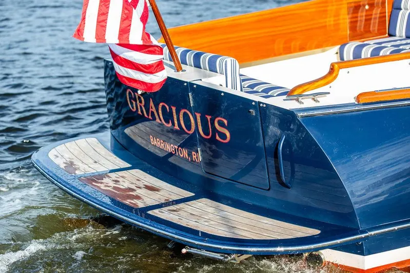 Gracious Yacht Photos Pics Hinckley Picnic Boat Mark III, 2011, with American flag, named "Gracious," docked in water.