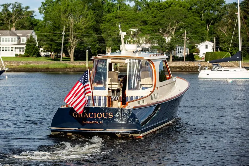 Gracious Yacht Photos Pics Hinckley Picnic Boat Mark III 2011 cruising on water with American flag displayed.