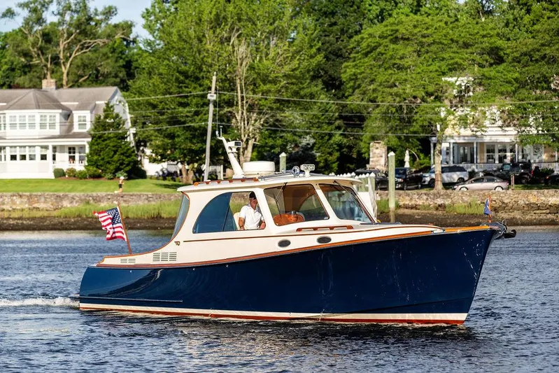Gracious Yacht Photos Pics 2011 Hinckley Picnic Boat Mark III cruising on a scenic river with lush greenery.
