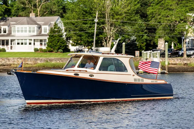 Gracious Yacht Photos Pics 2011 Hinckley Picnic Boat Mark III cruising on a scenic river with American flag.