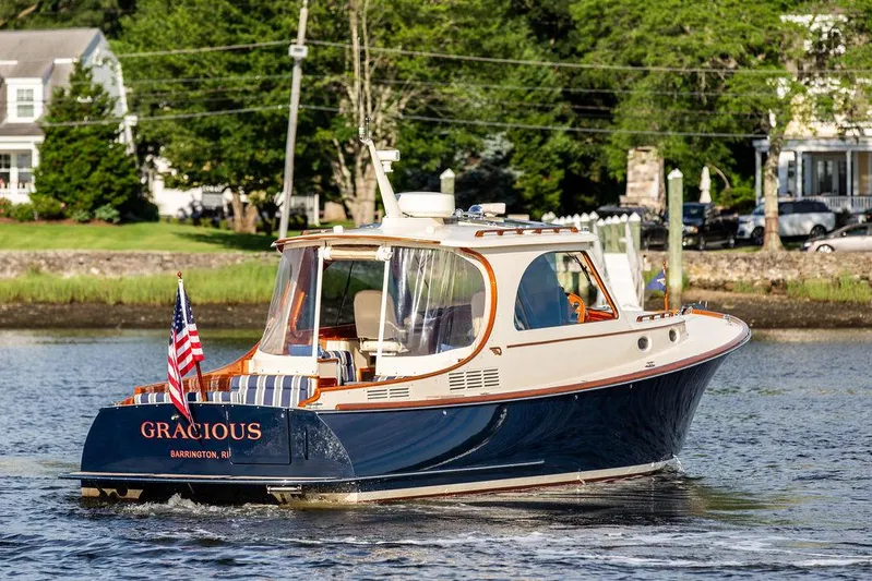 Gracious Yacht Photos Pics Hinckley Picnic Boat Mark III 2011 cruising on a scenic river with American flag.