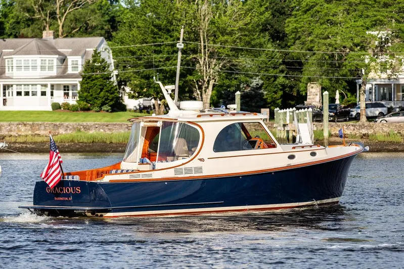 Gracious Yacht Photos Pics Hinckley Picnic Boat Mark III 2011 cruising on a scenic river with lush greenery.