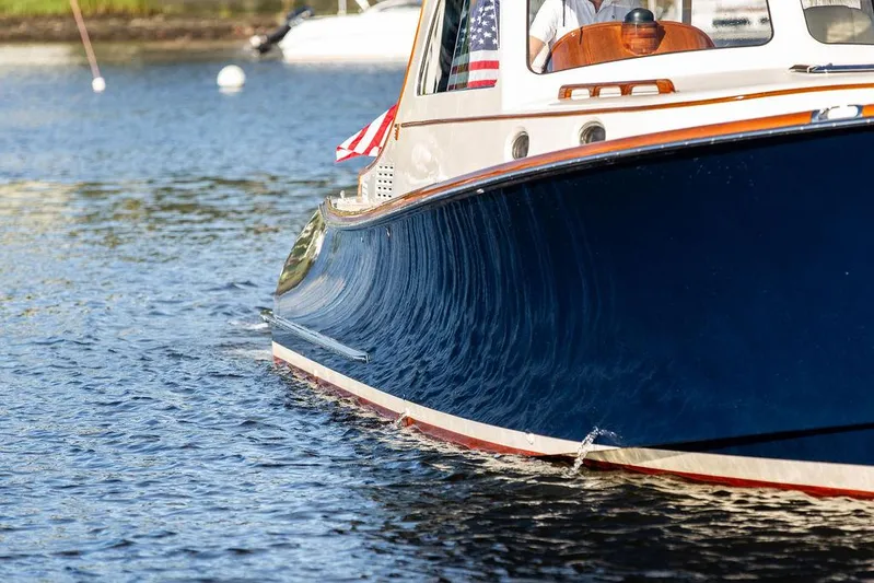 Gracious Yacht Photos Pics Hinckley Picnic Boat Mark III 2011 cruising on calm water, showcasing elegant design.