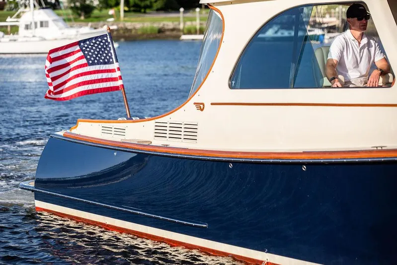 Gracious Yacht Photos Pics 2011 Hinckley Picnic Boat Mark III cruising with American flag on water.