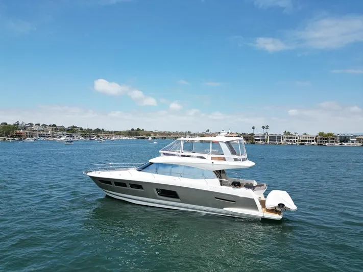 Florita Yacht Photos Pics 2016 Prestige 550 yacht cruising on a sunny day in a scenic harbor.