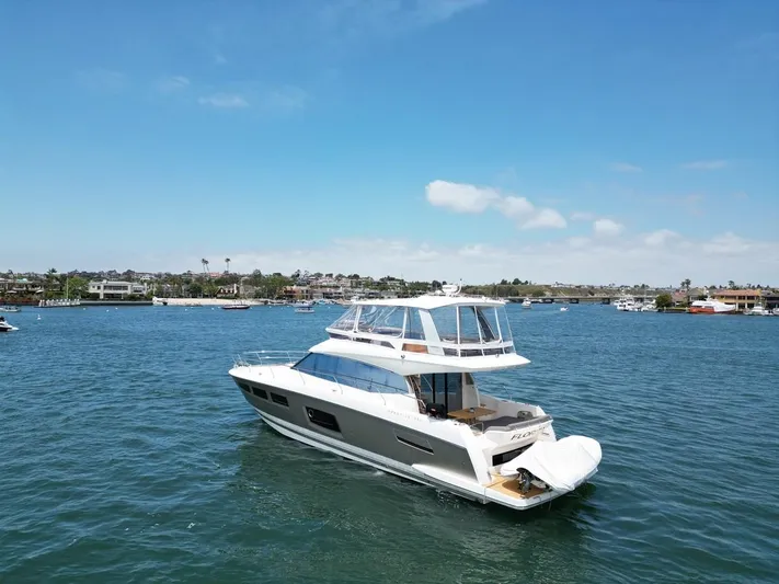 Florita Yacht Photos Pics 2016 Prestige 550 yacht cruising on a sunny day in a scenic harbor.