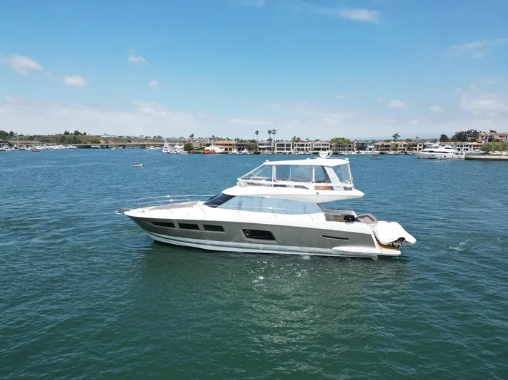 Florita Yacht Photos Pics 2016 Prestige 550 yacht cruising on a sunny day in a scenic harbor.