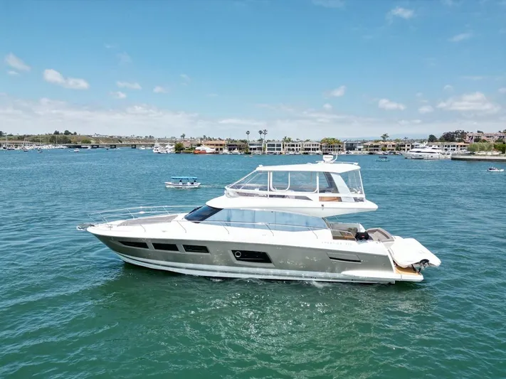 Florita Yacht Photos Pics 2016 Prestige 550 yacht cruising on a sunny day in a scenic harbor.