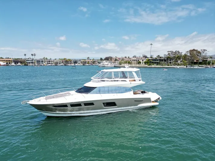 Florita Yacht Photos Pics 2016 Prestige 550 yacht cruising on a sunny day in a scenic harbor.