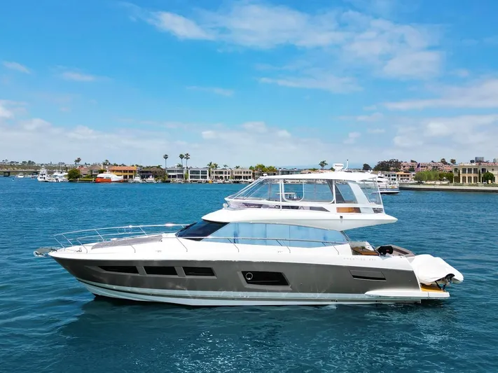 Florita Yacht Photos Pics 2016 Prestige 550 yacht cruising on a sunny day in a scenic harbor.