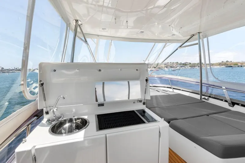 Florita Yacht Photos Pics Luxury yacht Prestige 550, 2016 model, featuring outdoor kitchenette and sunbathing area.