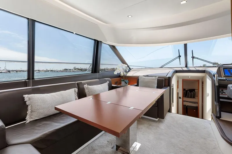 Florita Yacht Photos Pics Luxurious interior of 2016 Prestige 550 yacht with panoramic windows and elegant seating area.