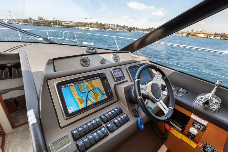 Florita Yacht Photos Pics Prestige 550 yacht helm with navigation system, 2016 model, overlooking scenic waterfront.