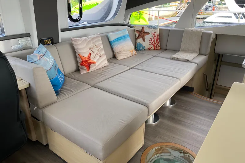 Weihaii Yacht Photos Pics Luxurious interior of 2023 Xquisite Yachts X5 PLUS with comfortable seating and decorative pillows.