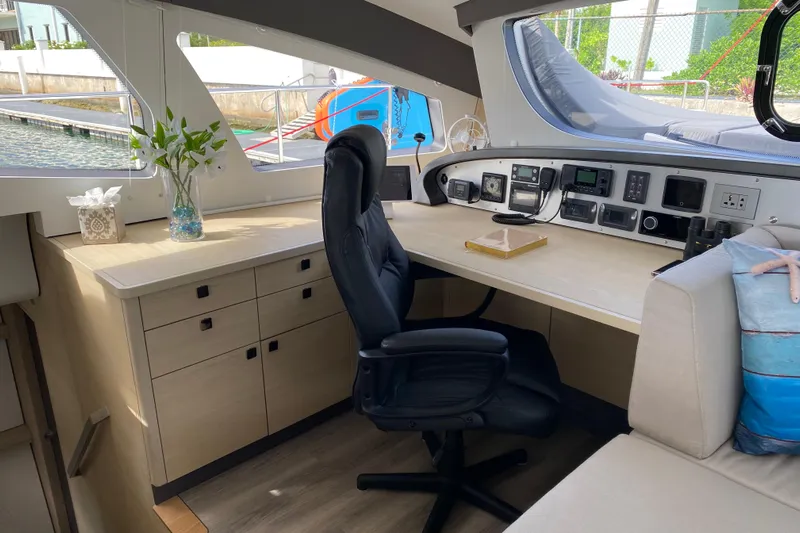 Weihaii Yacht Photos Pics Luxurious 2023 Xquisite Yachts X5 PLUS interior with modern navigation station and comfortable seating.