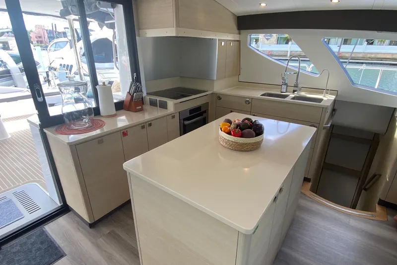 Weihaii Yacht Photos Pics Modern kitchen interior of 2023 Xquisite Yachts X5 PLUS, featuring sleek countertops and ample natural light.