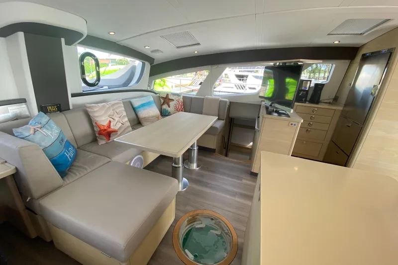 Weihaii Yacht Photos Pics Luxurious interior of 2023 Xquisite Yachts X5 PLUS with modern seating and decor.