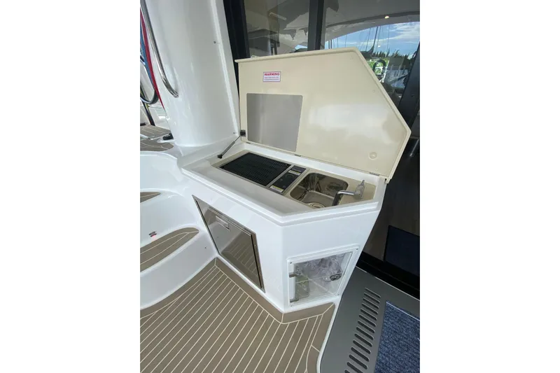 Weihaii Yacht Photos Pics Outdoor kitchenette on 2023 Xquisite Yachts X5 PLUS, featuring sink and grill.