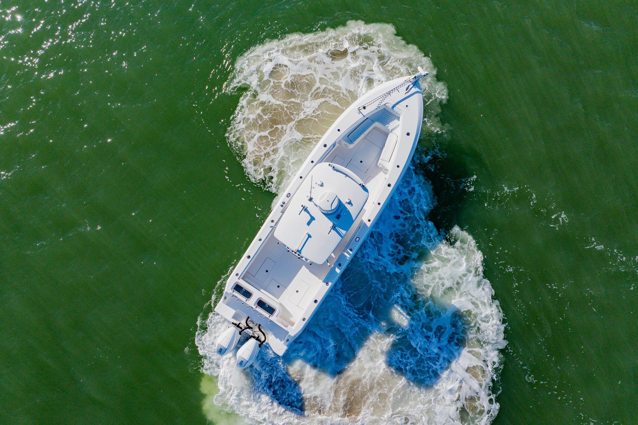 Aerial view of 2025 Contender 32 ST boat navigating through green waters.