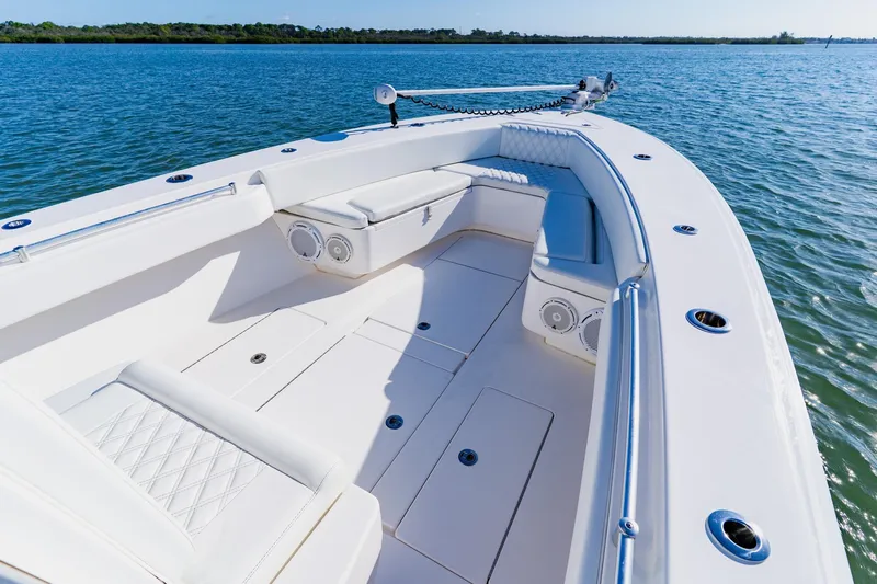  Yacht Photos Pics 2025 Contender 32 ST boat with spacious seating on calm water.