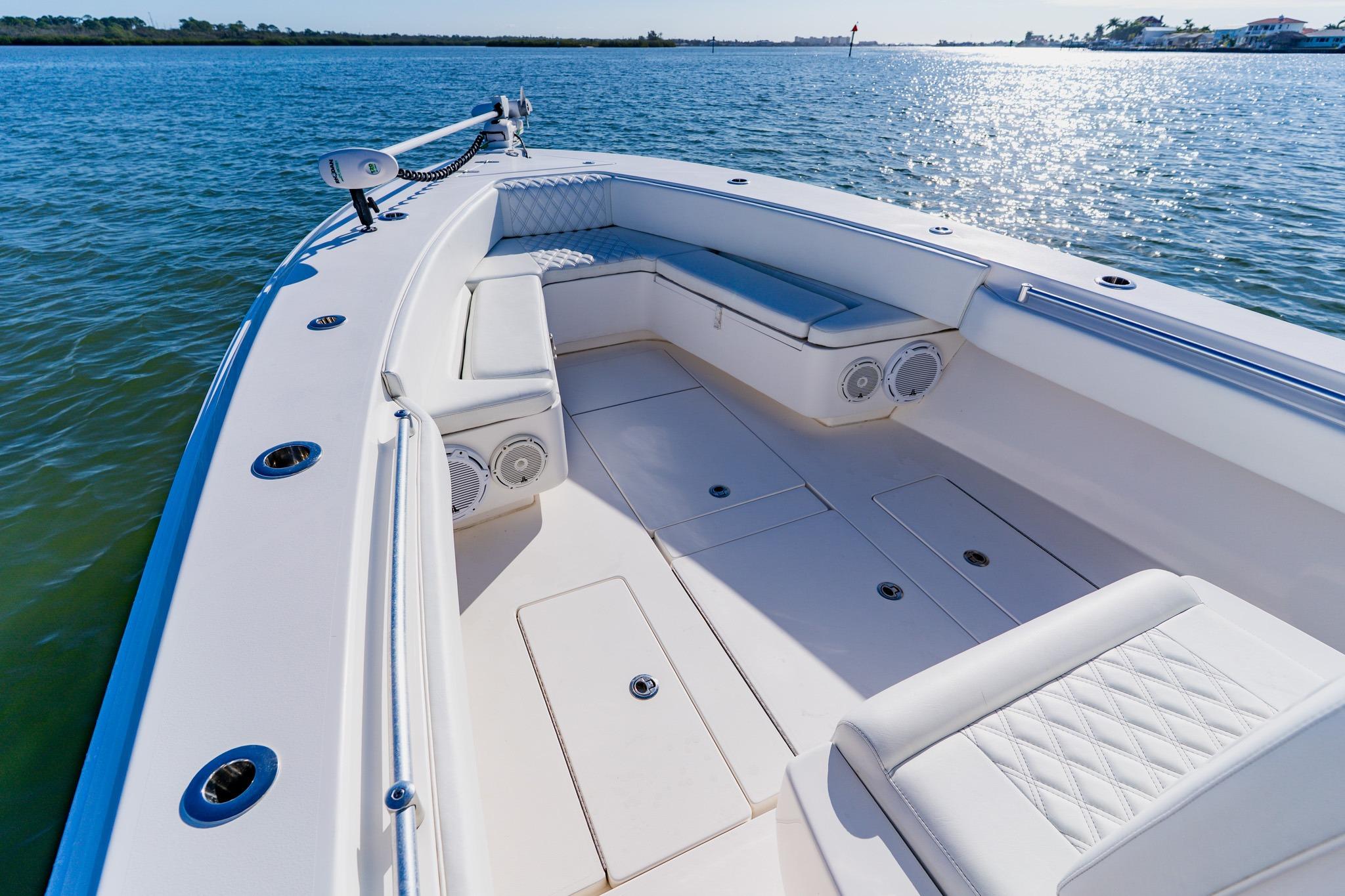 2025 Contender 32 ST boat interior with cushioned seating on calm water.
