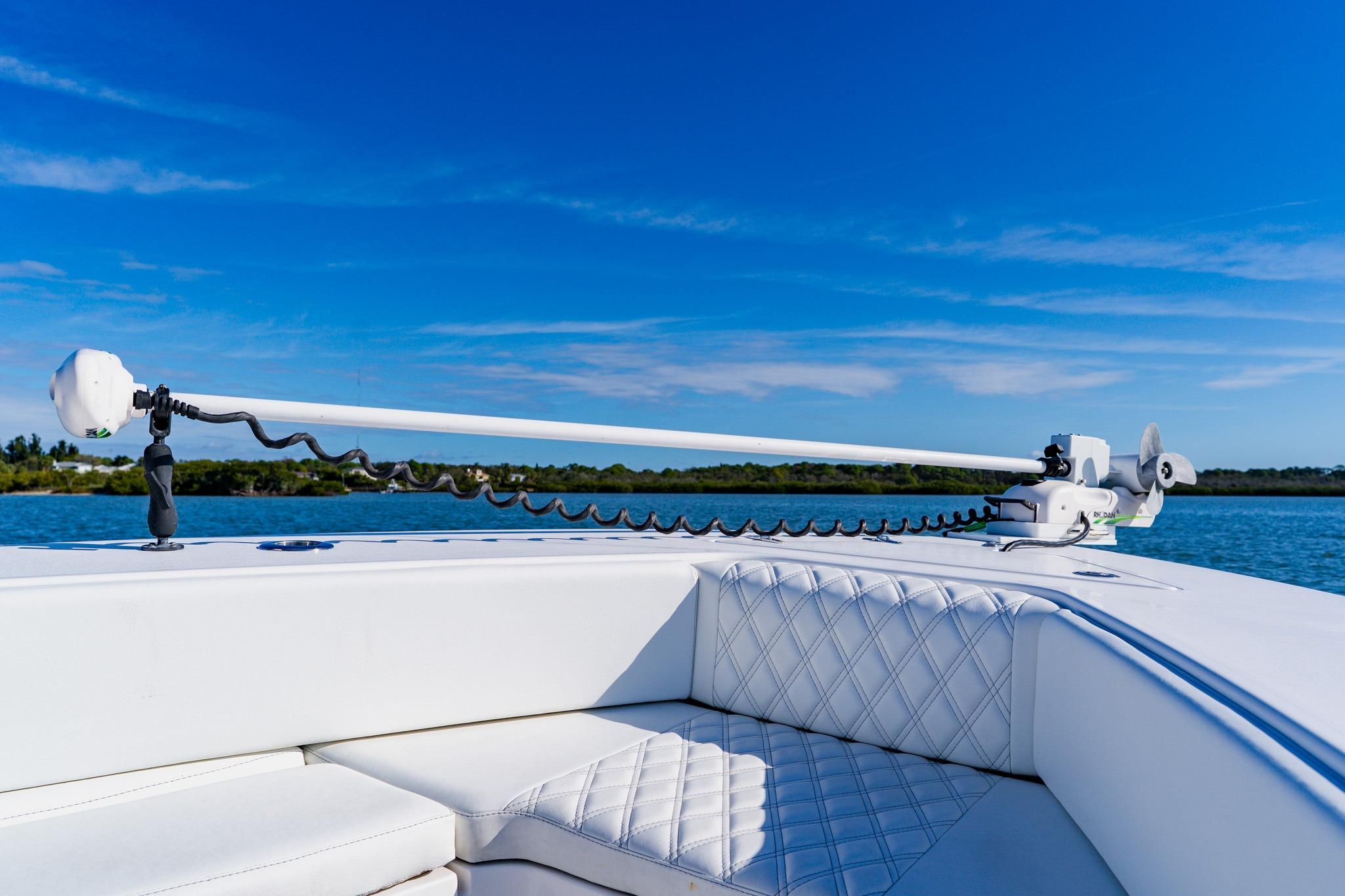 2025 Contender 32 ST boat with advanced trolling motor on calm water.