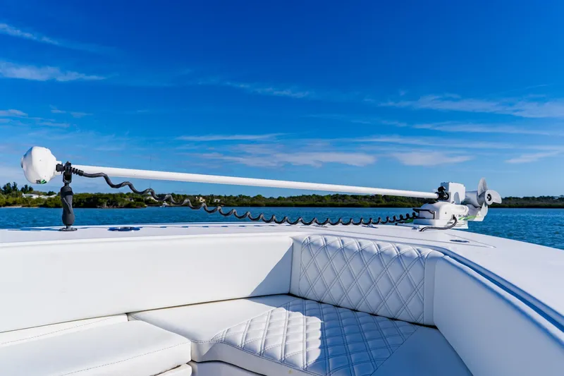  Yacht Photos Pics 2025 Contender 32 ST boat with advanced trolling motor on calm water.