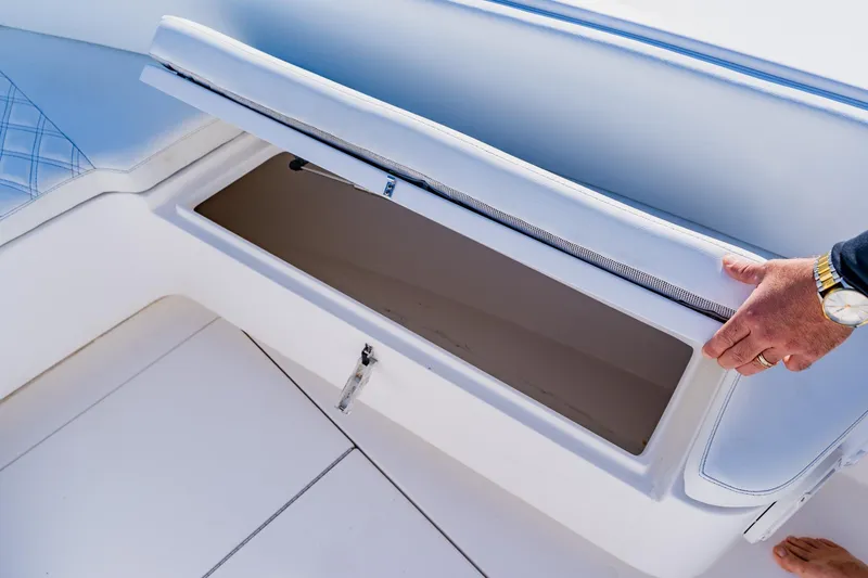  Yacht Photos Pics Contender 32 ST 2025 boat storage compartment with cushioned seating.
