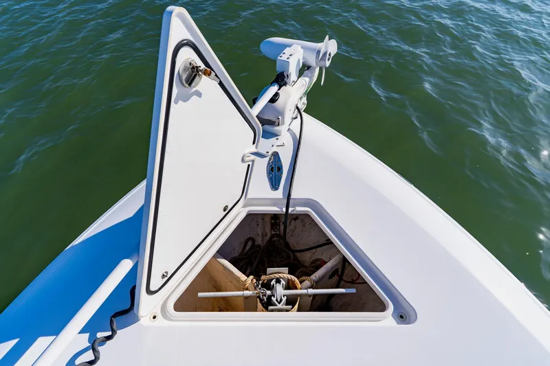  Yacht Photos Pics Bow of 2025 Contender 32 ST boat with open anchor hatch on water.
