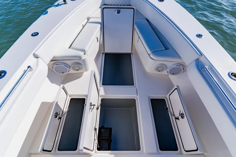  Yacht Photos Pics 2025 Contender 32 ST boat interior with open storage compartments and cushioned seating.