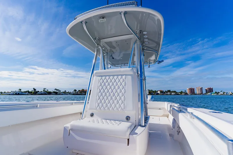  Yacht Photos Pics 2025 Contender 32 ST boat on water, featuring sleek design and luxurious seating.