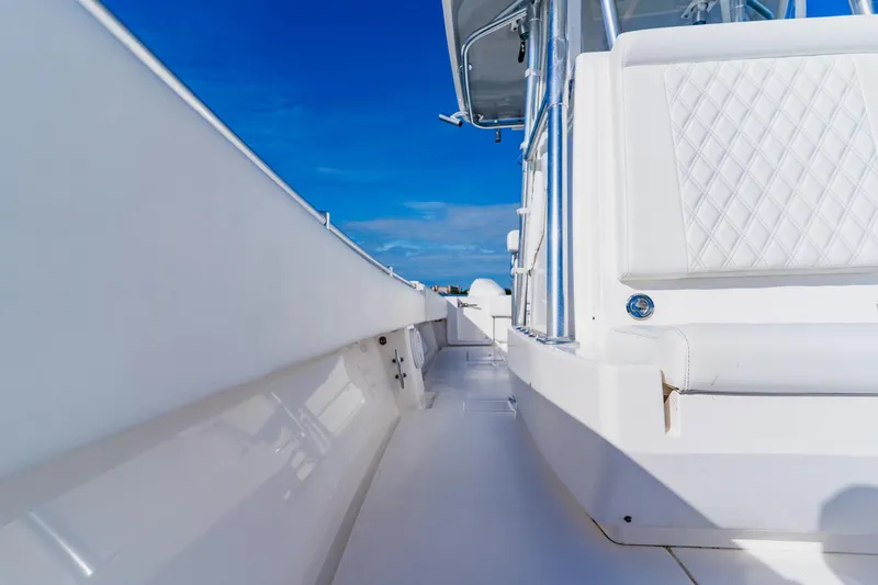  Yacht Photos Pics 2025 Contender 32 ST boat with sleek white interior and blue sky background.