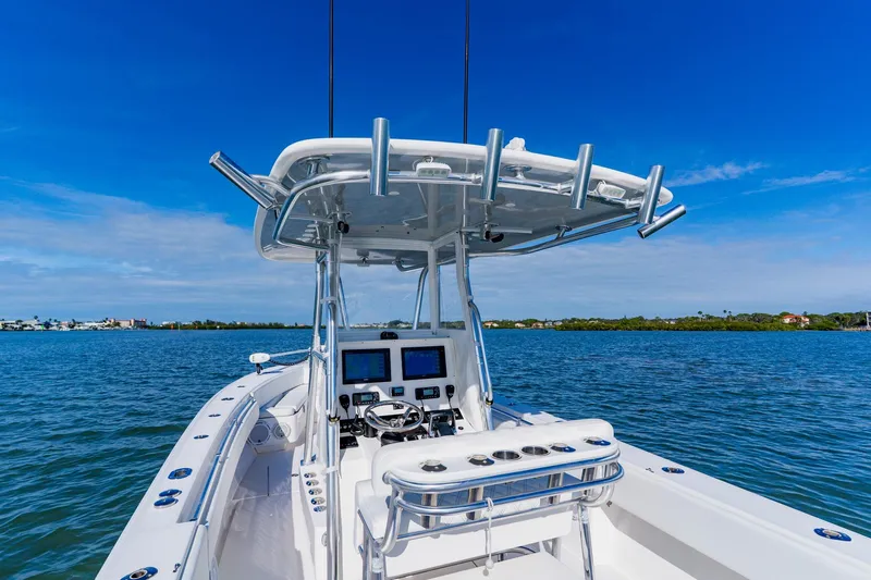  Yacht Photos Pics 2025 Contender 32 ST boat on calm water, featuring advanced navigation equipment.
