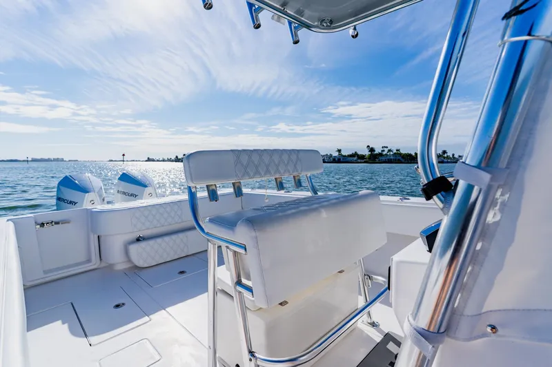  Yacht Photos Pics 2025 Contender 32 ST boat interior with dual Mercury engines, on a sunny day at sea.