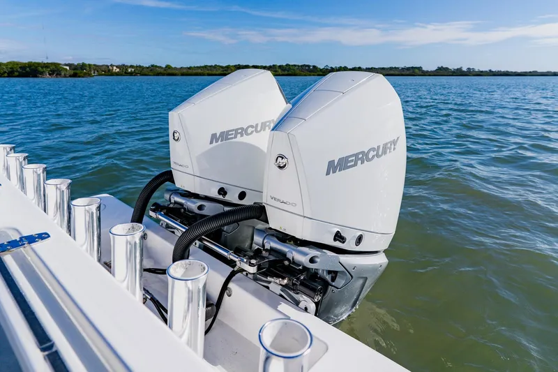  Yacht Photos Pics 2025 Contender 32 ST boat with dual Mercury outboard engines on a calm lake.