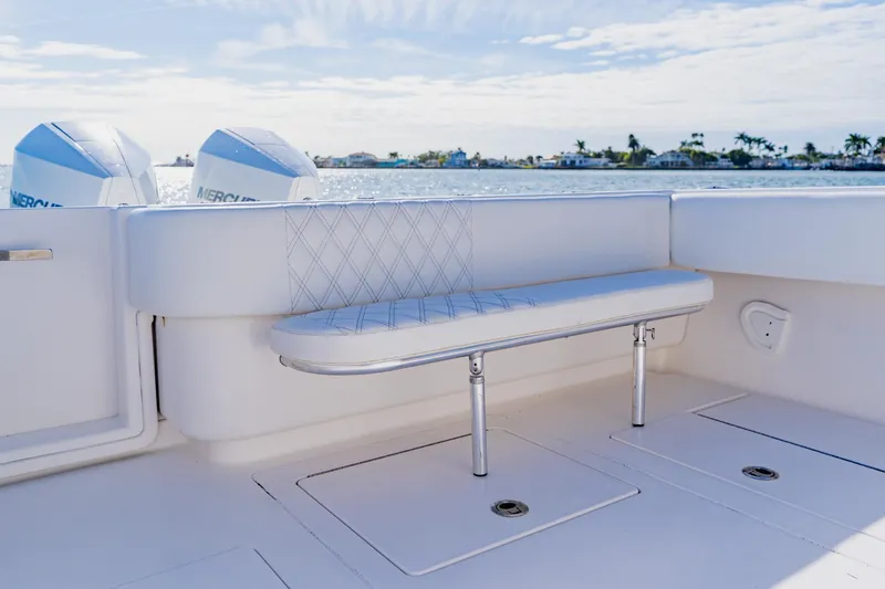  Yacht Photos Pics 2025 Contender 32 ST boat interior with white seating and dual Mercury engines.