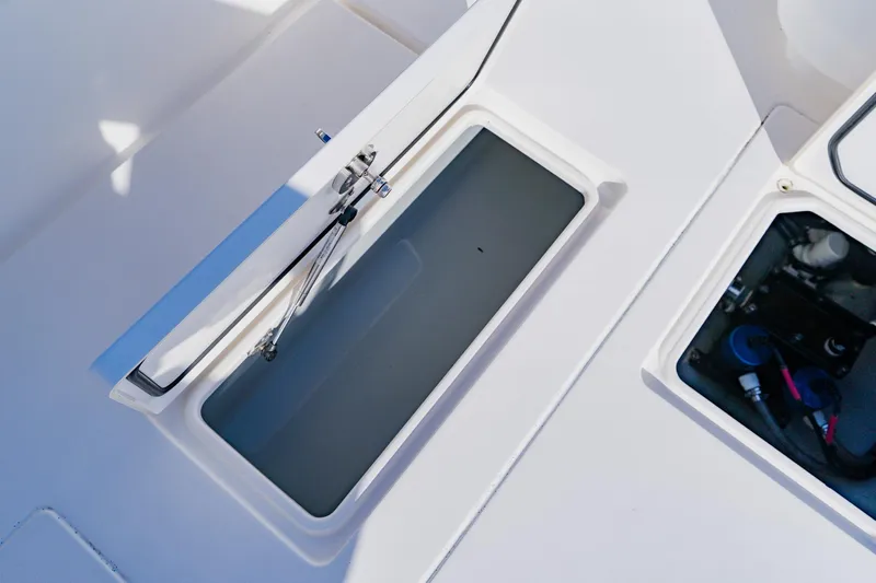  Yacht Photos Pics Open storage compartments on a 2025 Contender 32 ST boat deck.