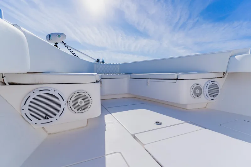  Yacht Photos Pics 2025 Contender 32 ST boat interior with seating and speakers under a clear blue sky.