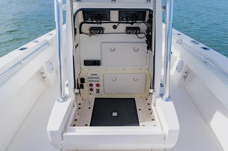  Yacht Photos Pics 2025 Contender 32 ST boat console with electronic controls and storage compartments.