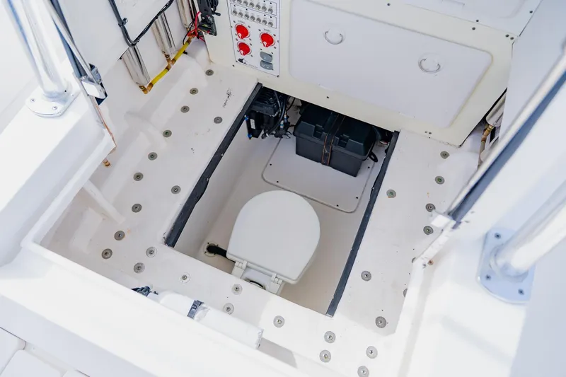  Yacht Photos Pics 2025 Contender 32 ST boat interior with a built-in marine toilet.