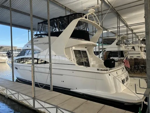 Why Knot Yacht Photos Pics 2003 Carver 410 Sport Sedan docked in a covered marina.