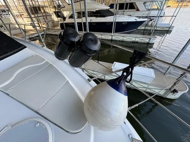 Why Knot Yacht Photos Pics 2003 Carver 410 Sport Sedan docked, featuring deck details and marina view.