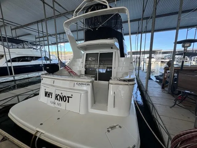 Why Knot Yacht Photos Pics 2003 Carver 410 Sport Sedan docked in marina, rear view with "Why Knot" nameplate.