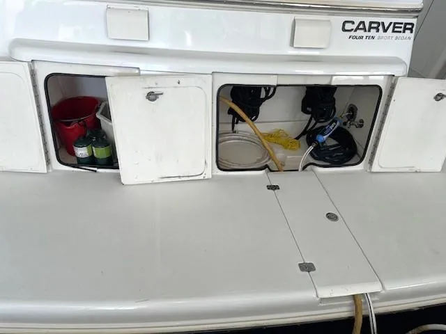 Why Knot Yacht Photos Pics 2003 Carver 410 Sport Sedan boat storage compartments with equipment and supplies.