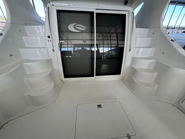 Why Knot Yacht Photos Pics 2003 Carver 410 Sport Sedan yacht interior with sliding glass door and steps.