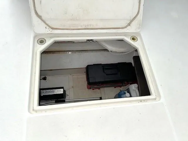 Why Knot Yacht Photos Pics Storage compartment on a 2003 Carver 410 Sport Sedan boat, featuring tools and equipment.