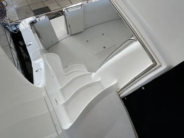 Why Knot Yacht Photos Pics 2003 Carver 410 Sport Sedan boat interior with white seating and deck.