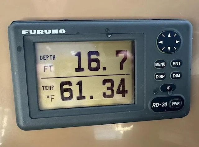 Why Knot Yacht Photos Pics Furuno depth and temperature display on 2003 Carver 410 Sport Sedan, showing 16.7 ft depth, 61.34&deg;F.