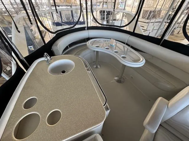 Why Knot Yacht Photos Pics 2003 Carver 410 Sport Sedan interior with seating and built-in sink.